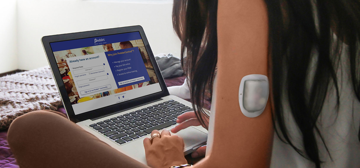 Omnipod - girl with pod on arm using laptop