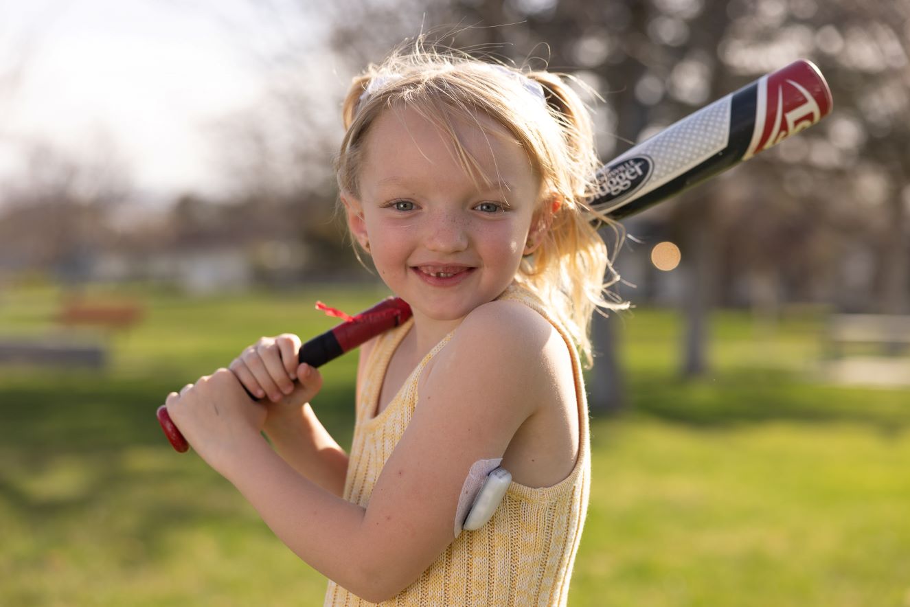Romey holding baseball bat