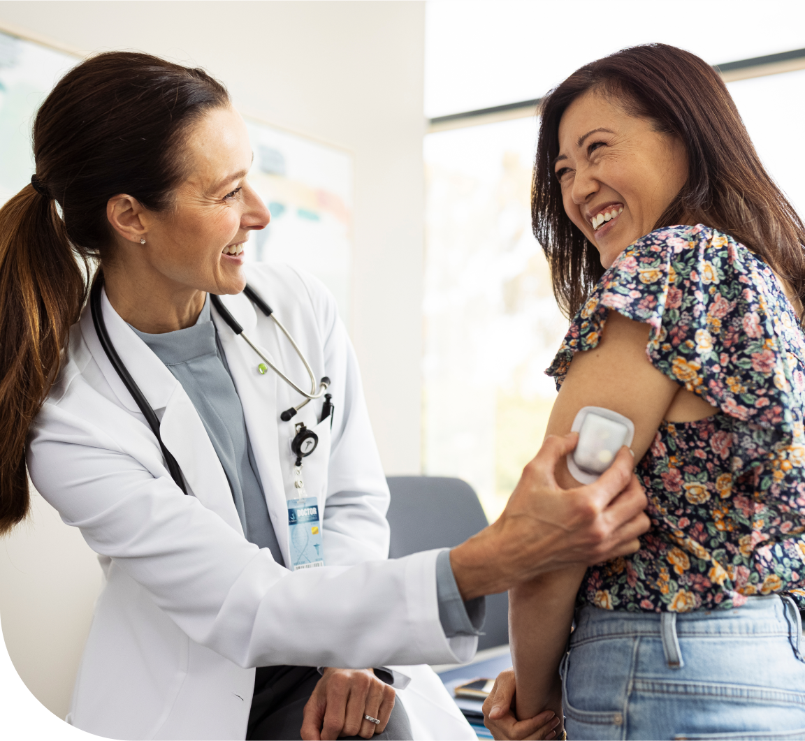 HCP in white lab coat holding a Pod on patient's arm