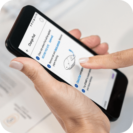 Person tapping the screen of their PDM for Omnipod DASH