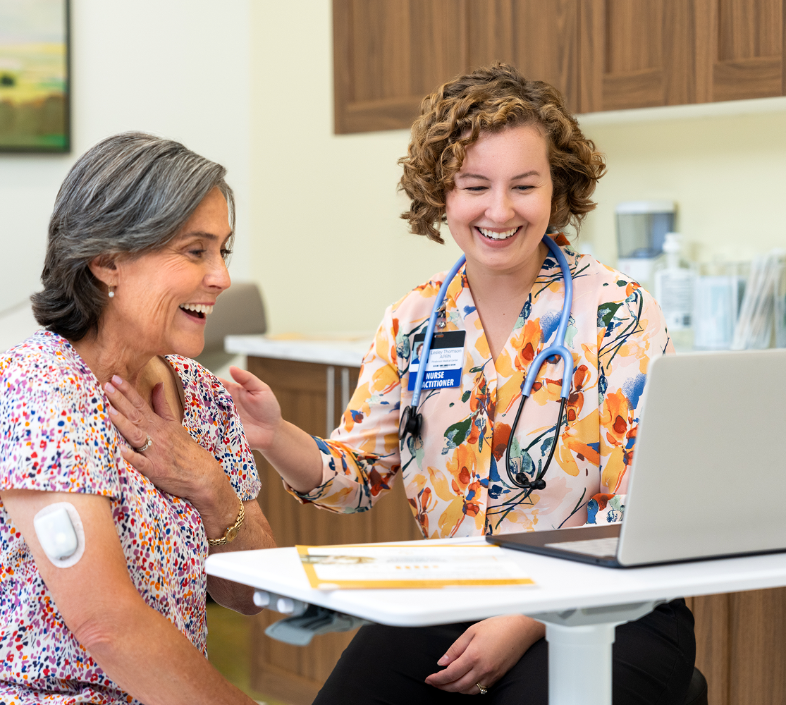 HCP nurse with patient looking at a laptop screen in amazement