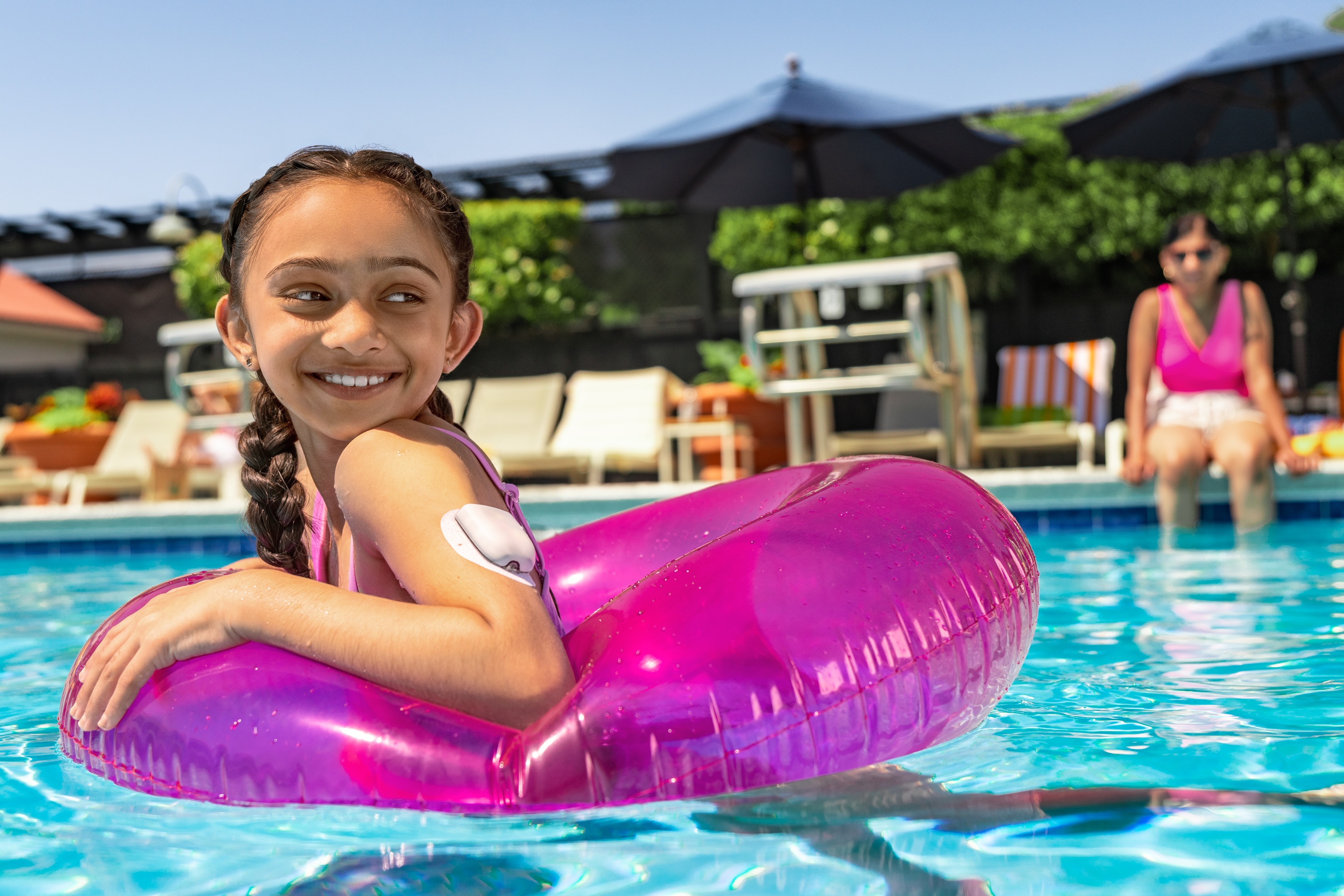 Girl in the swimming pool wearing a Pod (insulin pump)