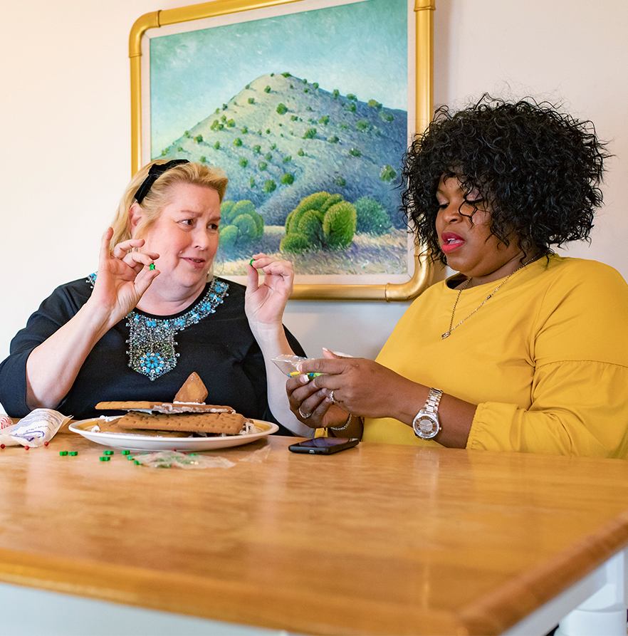 Two women around the table preparing a meal