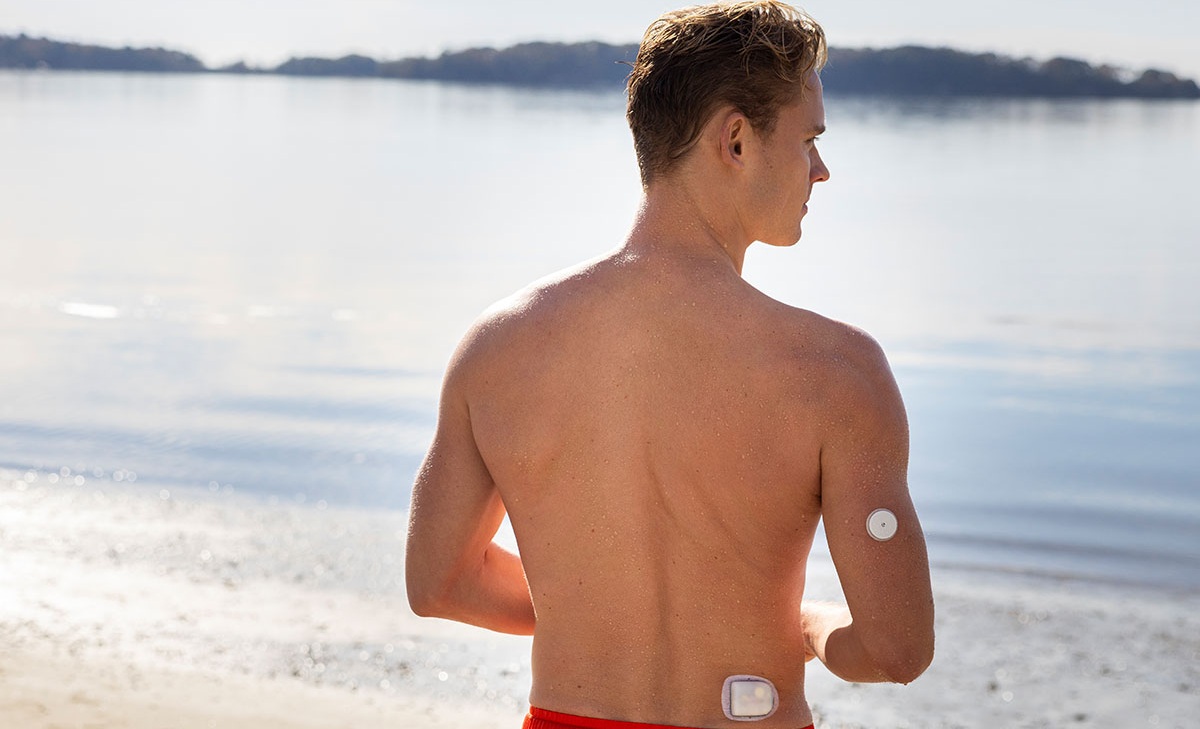 Man on the beach with insulin pump