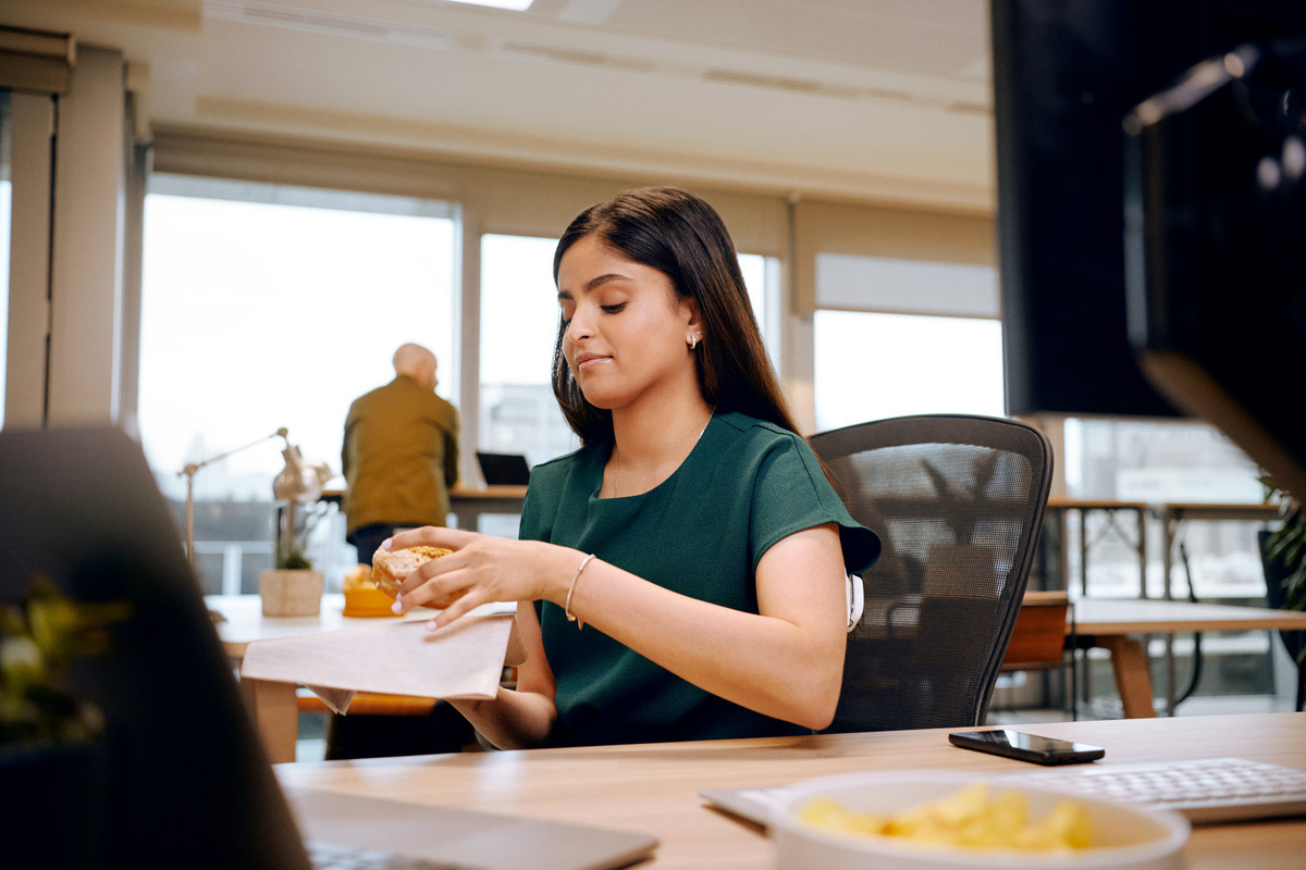 Omnipod Podder sitting in an office while wearing a green t-shirt.