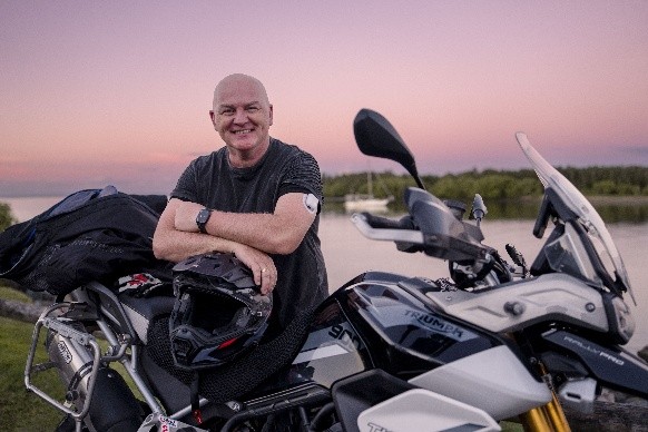 Podder Scott, standing by his motorbike