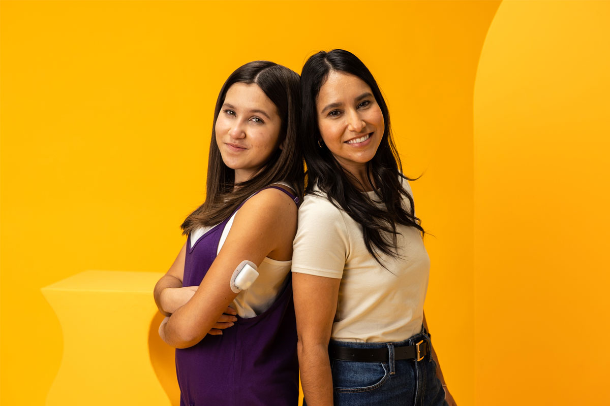 daughter and mom standing back to back