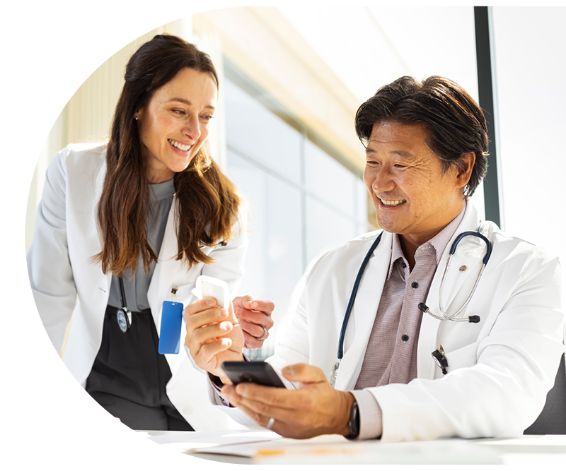 Healthcare professionals looking at devce