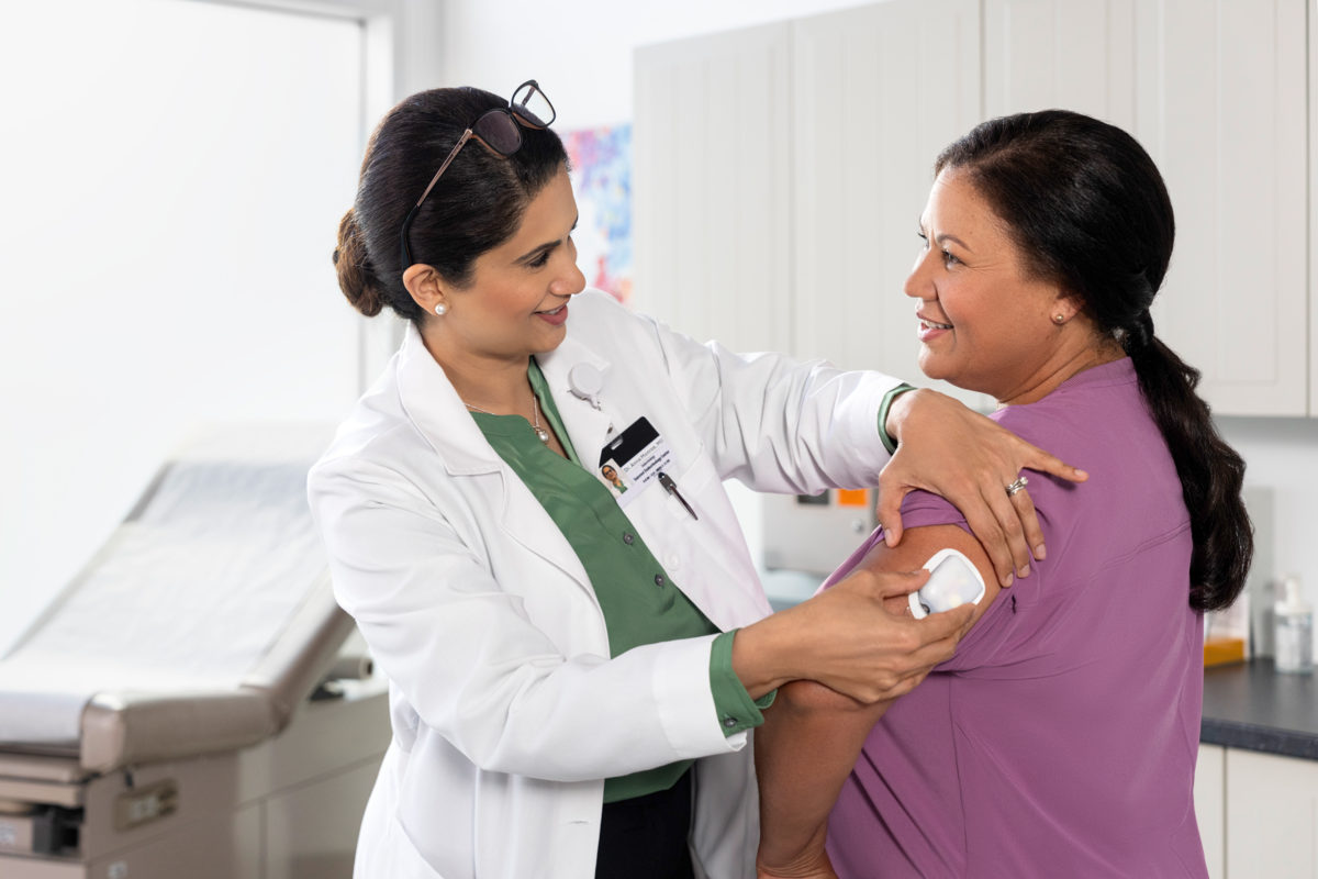 A healthcare professional placing an Omnipod on a new patient