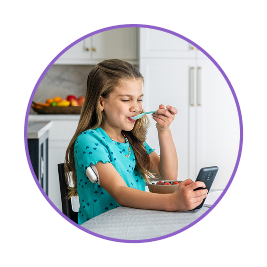 Child podder, eating breakfast whilst managing diabetes on device