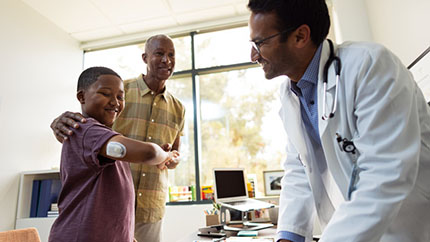 HCP with father and son, who has an Omnipod Pod on his arm