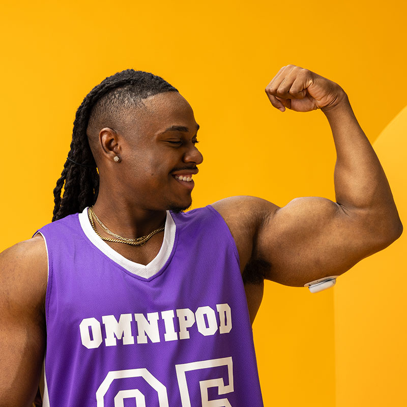 Podder, wearing an omnipod, with his arm up, showing muscles