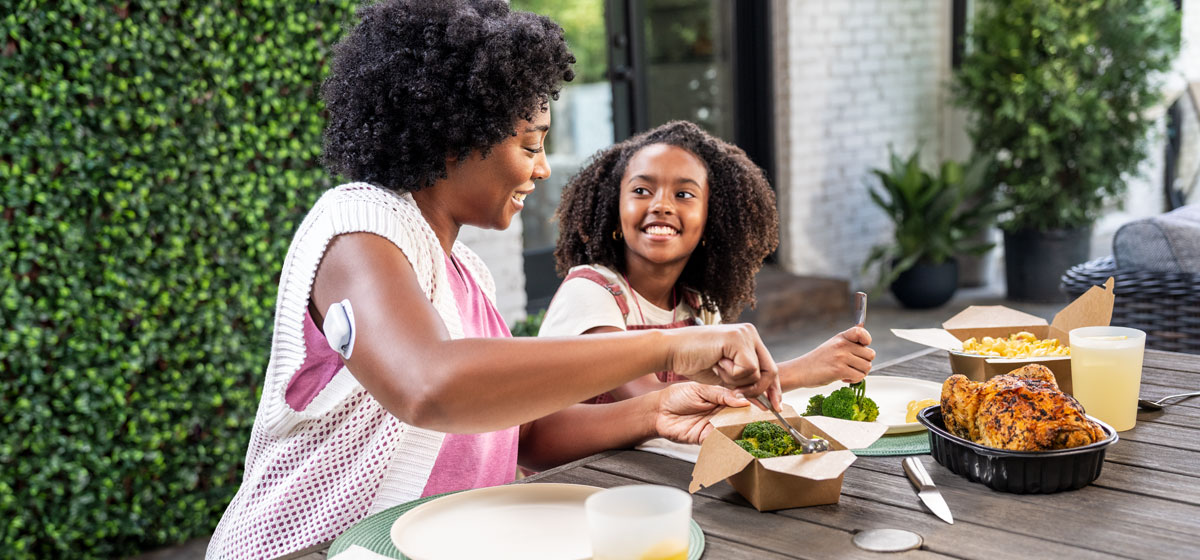 mom and daughter eating outside