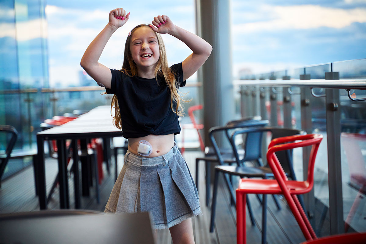 young girl with hands raised