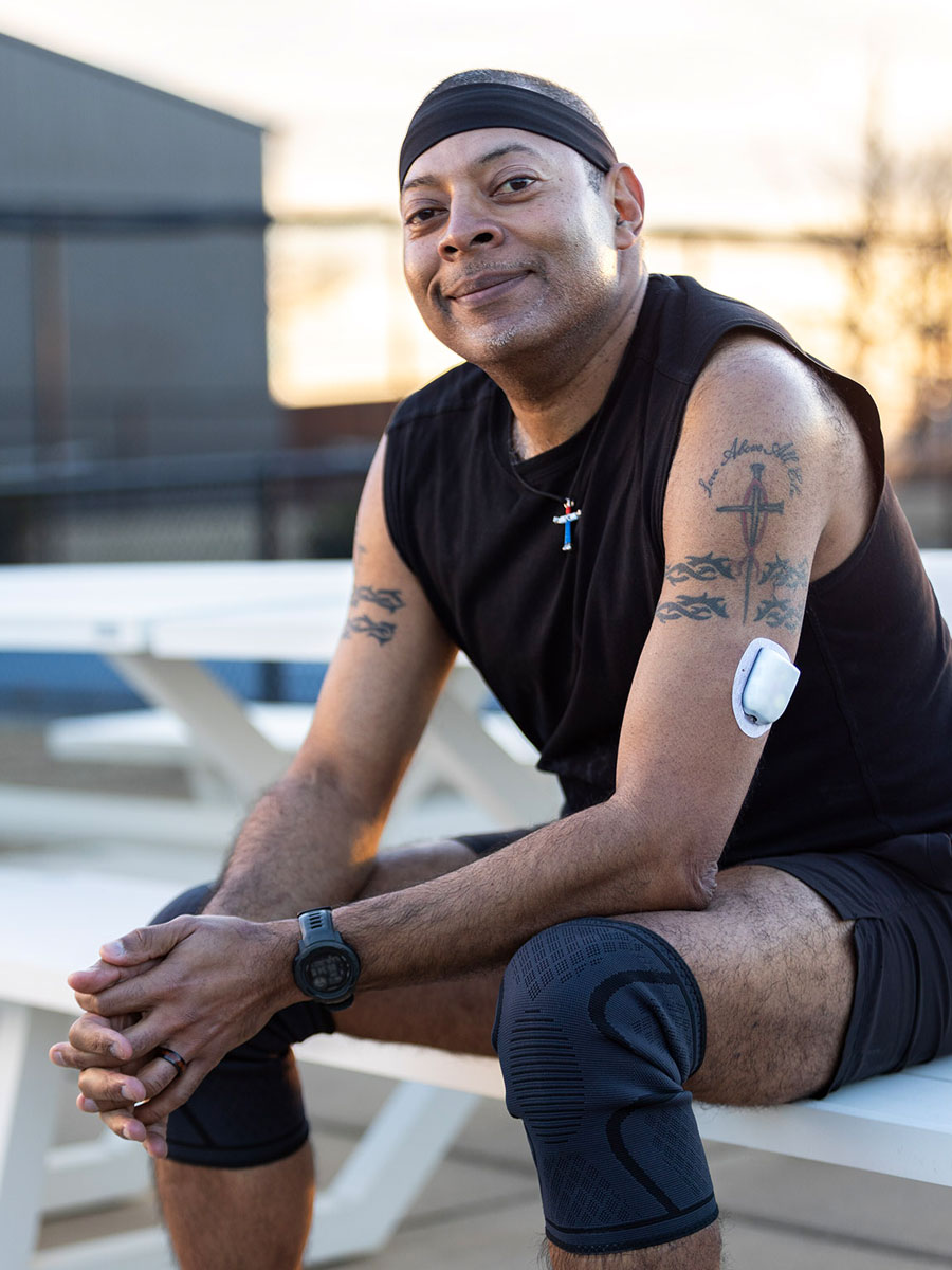 man sitting proud with pod placed on his arm