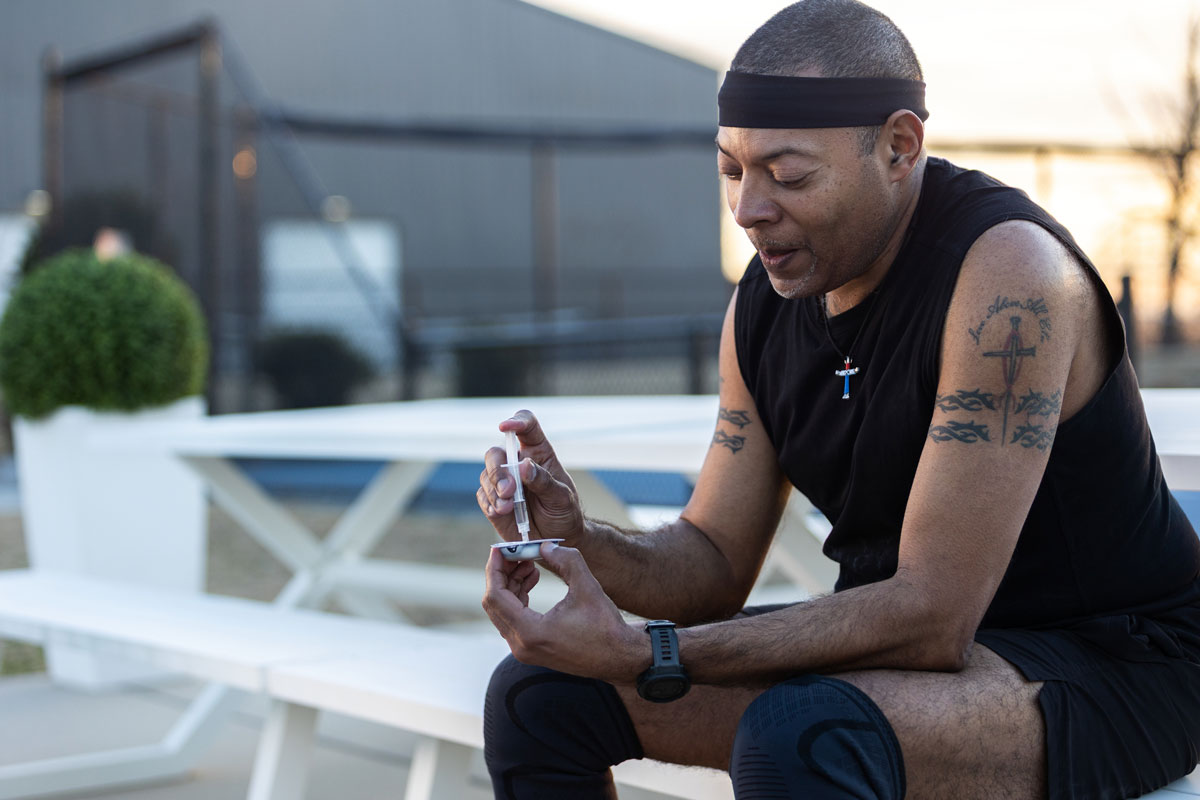man refilling pod with insulin