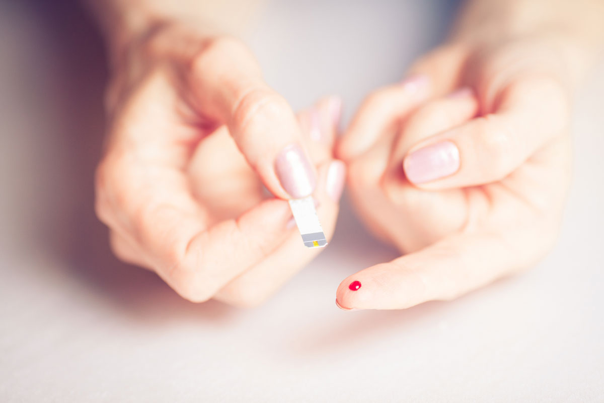 blood on finger to put on a test strip