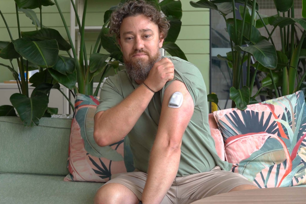 Man holding his sleeve up to show the Pod on his arm