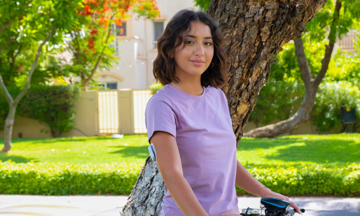 Podder standing with her bicycle