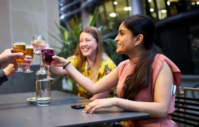 Podder, cheering beverages with friends