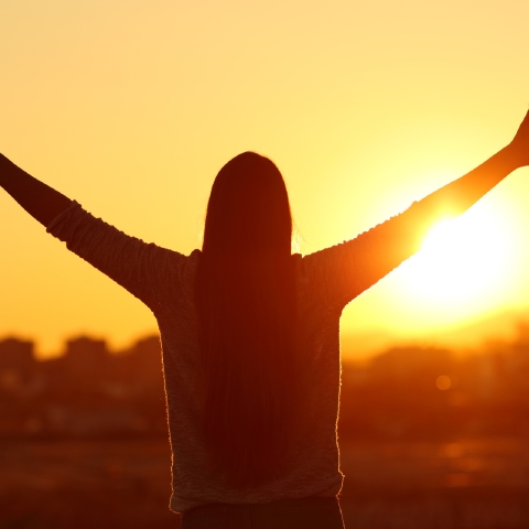 Woman staring at sunrise