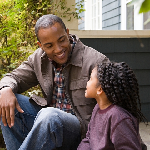 Dad looking at child, smiling