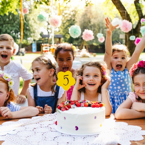 Kids gathered around a birthday cake