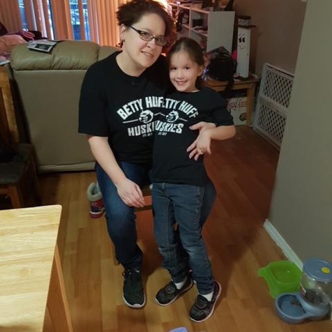 Mom and daughter sitting together wearing matching t-shirts