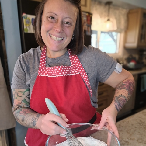 Woman wearing a festive apron and baking