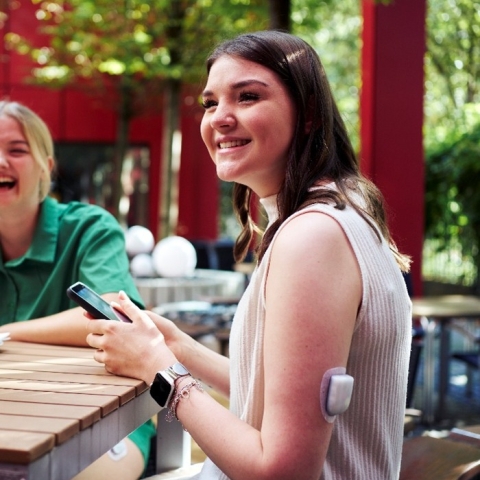 Omnipod Podder, Cindy, sitting at a table with a Pod on her left arm