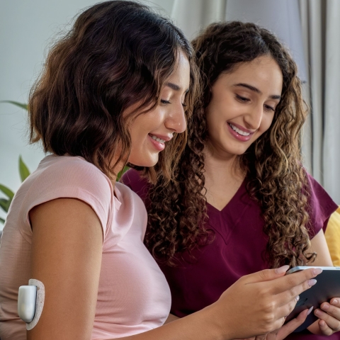 Podder on an iPad with a friend