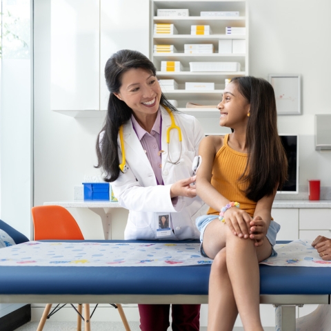 HCP with child and mother in an exam room