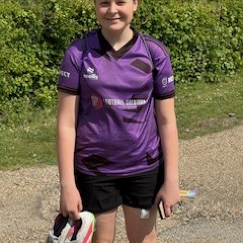 Podder, Skye wearing her football kit and holding her trainers